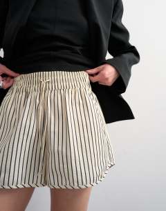 Model wearing Crinkle stripe runner short in mono