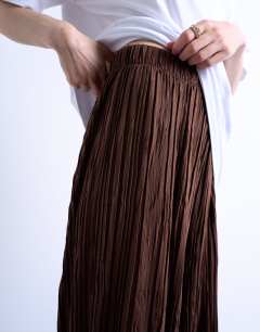 Model wearing Crinkle wide leg trousers in chocolate brown