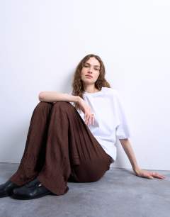 Model wearing Crinkle wide leg trousers in chocolate brown