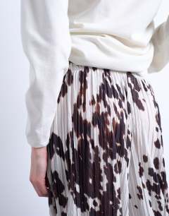 Model wearing Crinkle wide leg trousers in cow print
