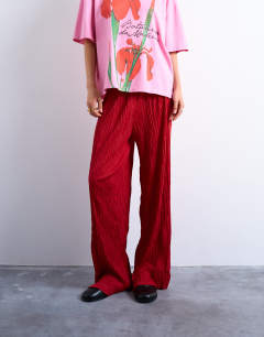 Model wearing Crinkle wide leg trousers in red