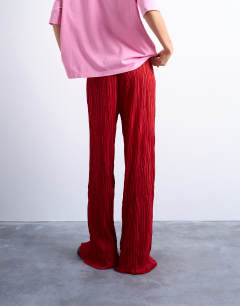 Model wearing Crinkle wide leg trousers in red