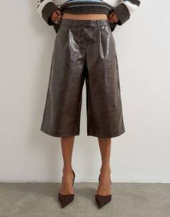 Model wearing Croc faux leather a line bermuda in chocolate