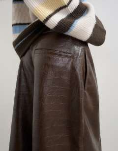 Model wearing Croc faux leather a line bermuda in chocolate