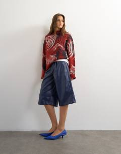 Model wearing Croc faux leather bermuda short in navy