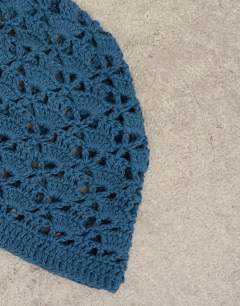 Model wearing Crochet beanie hat in deep blue