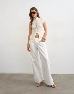 Model wearing Crochet cap sleeve button top in cream