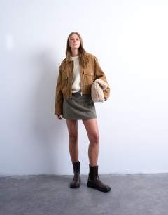 Model wearing Cropped faux suede bomber jacket with popper details in camel
