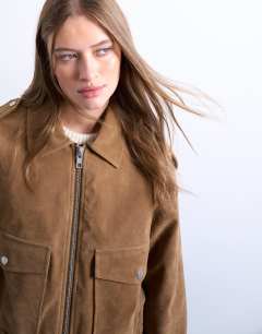 Model wearing Cropped faux suede bomber jacket with popper details in camel