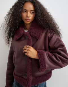 Model wearing Cropped shearling jacket in burgundy