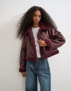 Model wearing Cropped shearling jacket in burgundy