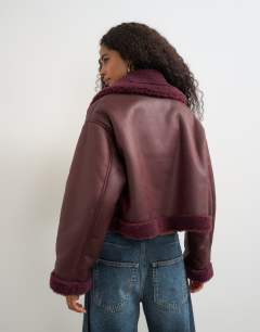Model wearing Cropped shearling jacket in burgundy