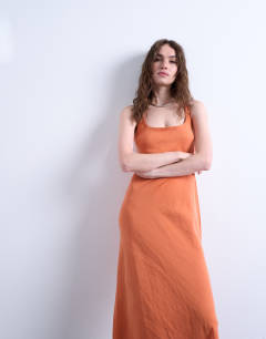 Model wearing Cross back midi cupro dress in orange