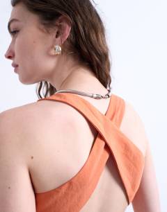 Model wearing Cross back midi cupro dress in orange