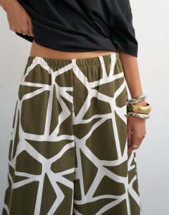 Model wearing Culotte in green abstract