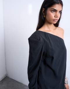 Model wearing Cupro asymmetric top with shoulder pads in black