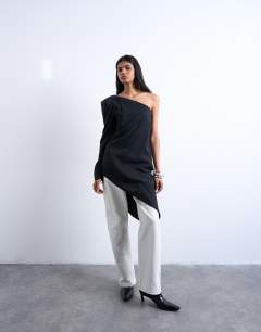 Model wearing Cupro asymmetric top with shoulder pads in black