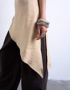 Model wearing Cupro asymmetric top with shoulder pads in stone