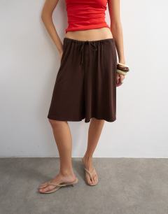 Model wearing Cupro bermuda drawstring shorts in brown