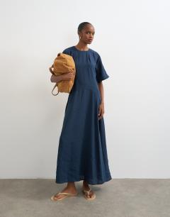 Model wearing Cupro dropped waist maxi t-shirt dress in navy