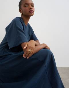 Model wearing Cupro dropped waist maxi t-shirt dress in navy