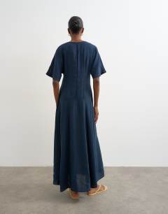 Model wearing Cupro dropped waist maxi t-shirt dress in navy