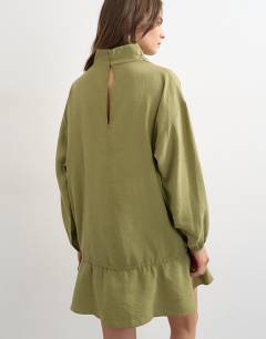 Model wearing Cupro funnel neck dropped waist long sleeve mini dress in khaki