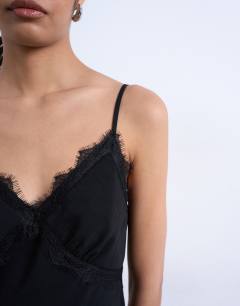 Model wearing Cupro lace trim midi slip dress in black