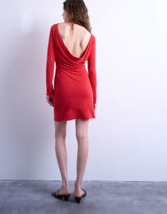 Model wearing Cupro long sleeve cowl back mini dress in red