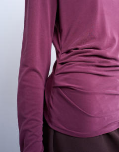 Model wearing Cupro long sleeve hitch side detail top in burgundy