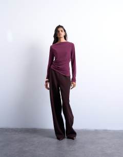 Model wearing Cupro long sleeve hitch side detail top in burgundy