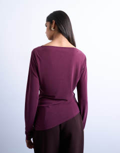 Model wearing Cupro long sleeve hitch side detail top in burgundy