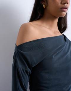 Model wearing Cupro off shoulder tunic long sleeve top in charcoal grey