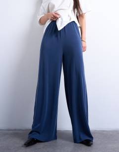 Model wearing Cupro pull on wide leg trousers in navy