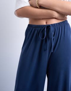 Model wearing Cupro pull on wide leg trousers in navy