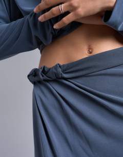 Model wearing Cupro twist detail maxi skirt co-ord in charcoal grey