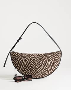 Model wearing Curly canvas scoop shoulder bag in zebra