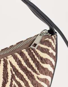 Model wearing Curly canvas scoop shoulder bag in zebra