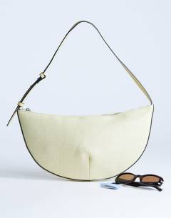 Model wearing Curly medium canvas scoop shoulder bag in lemon