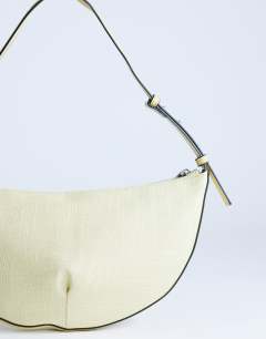 Model wearing Curly medium canvas scoop shoulder bag in lemon