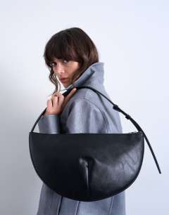 Model wearing Curly medium scoop shoulder bag in black