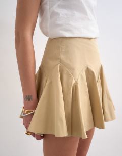 Model wearing Curved godet hem mini skirt in tan