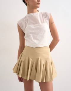 Model wearing Curved godet hem mini skirt in tan