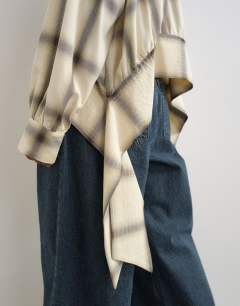 Model wearing Curved hem blouse in neutral check