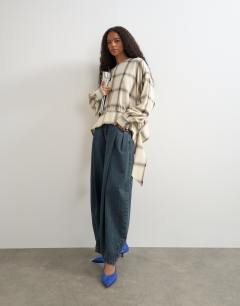 Model wearing Curved hem blouse in neutral check