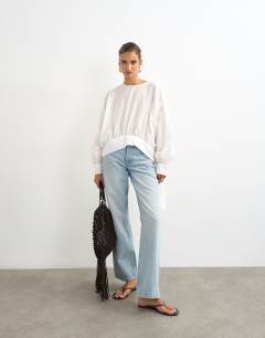 Model wearing Curved hem blouse in white