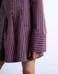 Model wearing Cut about long sleeve mini dress in burgundy stripe