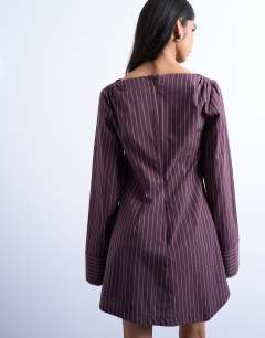 Model wearing Cut about long sleeve mini dress in burgundy stripe