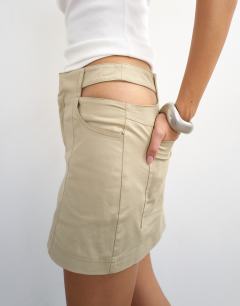 Model wearing Cut away micro mini skirt in stone