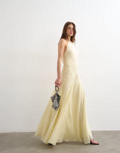 Model wearing Cut away racer neck full skirt maxi dress in buttermilk